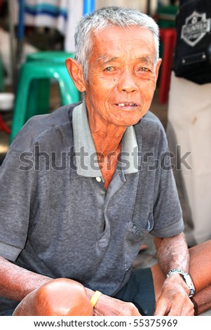 BANGKOK, THAILAND - NOVEMBER 29: Elderly Thai man sits begging for money in Chatuchak market on November 29, 2008 in Bangkok.