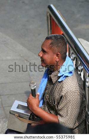 BANGKOK, THAILAND - NOVEMBER 29: Blind man sits and plays music for money by the road on November 29, 2008 in Bangkok.