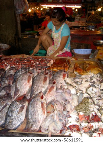 stock photo : PATTAYA, THAILAND - JUNE 2: Thai woman sells fish in a