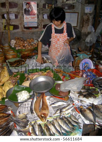 PATTAYA, THAILAND - JUNE 2: Thai woman sells fish in a market on June 2, 2005 in Pattaya.