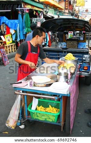 BANGKOK - JANUARY 19: Thai man sells food on Khaosarn road on January 19, 2011 in Bangkok, Thailand.