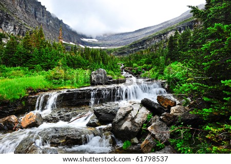 Waterfalls with fog in the background at Glacier National Park, along the Going To The Sun Road.
