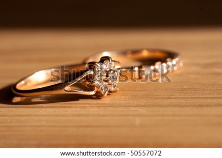 a golden rings on wooden desk in the sunshine