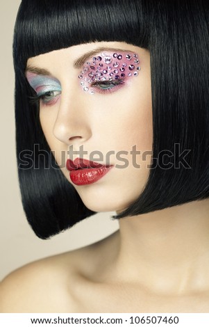 Fashion photo of young woman with dark hair. Woman in black wig