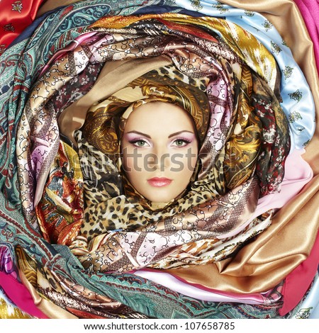 Young woman face with scarves. Close-up portrait