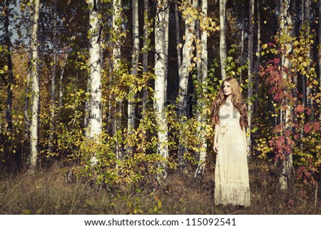 Fashion portrait of a beautiful young woman in autumn forest. Beauty autumn