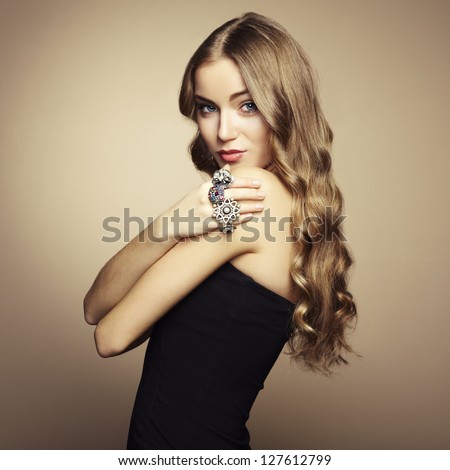 Portrait of beautiful blonde woman in black dress. Fashion photo