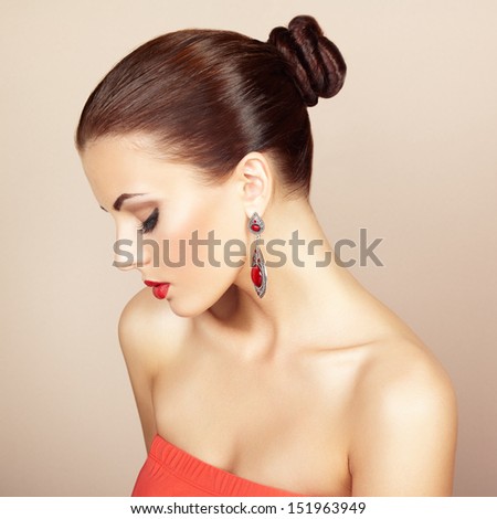 Portrait Of Beautiful Brunette Woman With Earring. Perfect Makeup. Fashion Photo