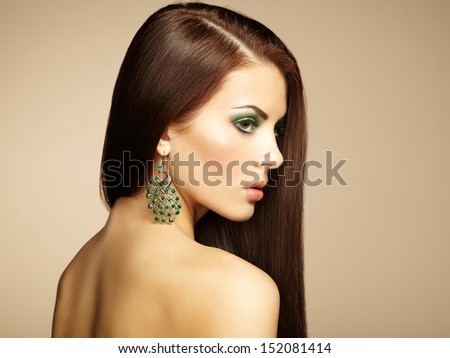 Portrait Of Beautiful Brunette Woman With Earring. Perfect Makeup. Fashion Photo