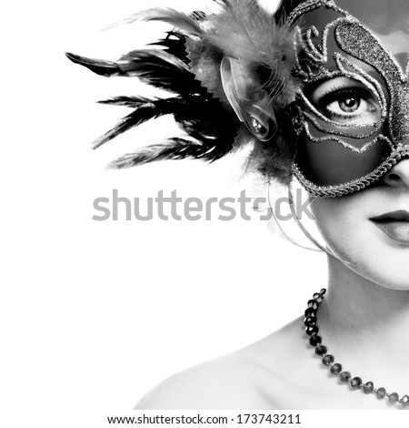 The beautiful young woman in mysterious venetian mask. Black and white photo