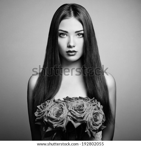 Portrait of beautiful dark-haired woman with flowers. Black and White photo