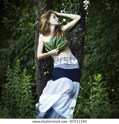 Portrait of romantic woman at the green forest