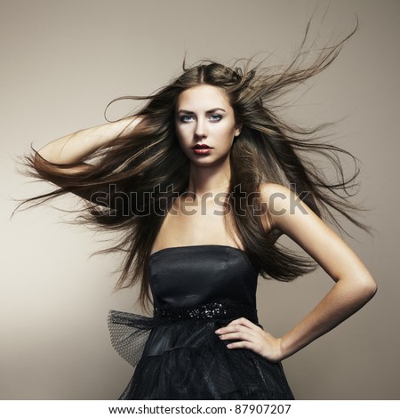 Portrait of young dancing woman with long flowing hair. Fashion photo