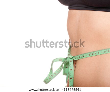 Close-up of slim stomach with measuring tape around it Woman body part is being measured