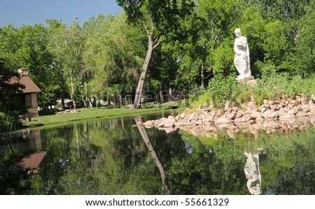 Reflections-Old statue in pond Wamego,Kansas This is correct spelling