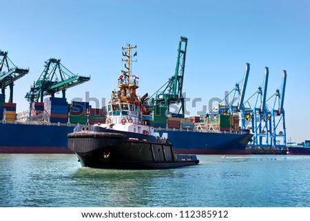 Cargo sea port. Sea cargo cranes. Tug.