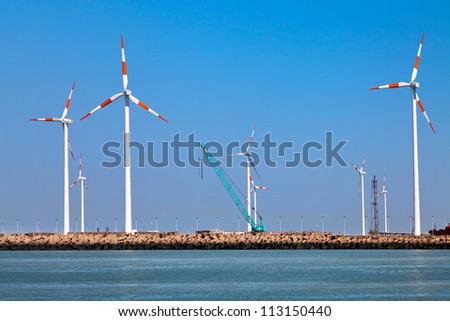 Cargo sea port. Wind turbines. Sea.