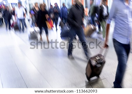 A crowd moving against a background of an urban landscape. Motion blur. Walking businessmen against a background of an urban landscape.