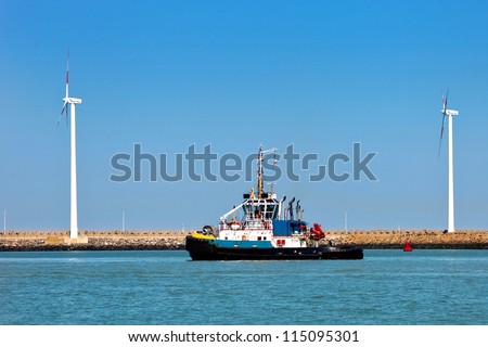 Cargo sea port. Wind turbines. Sea. Tug.