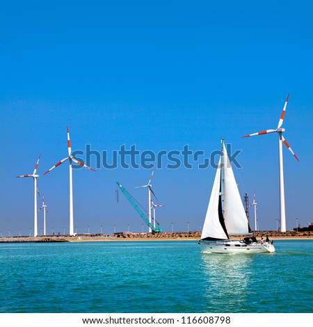 Cargo sea port. Wind turbines. Sea. Yacht.