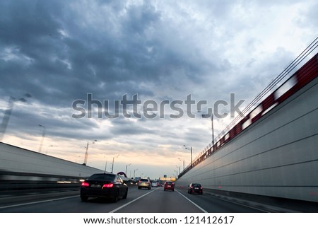 Cars on the highway-evening. The urban landscape.
