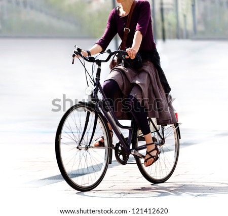 he woman on the bike after work. Urban scene.