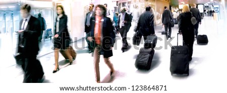 A large group of arriving businessmen. Panorama. Motion blur.