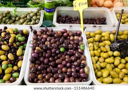 Trays with black olives. Fruit and vegetable market.