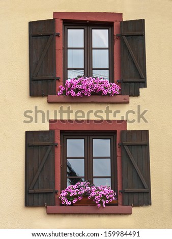 Windows with shutters and flowers. Old windows.