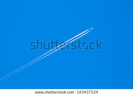 The plane in the blue sky. Flying plane.