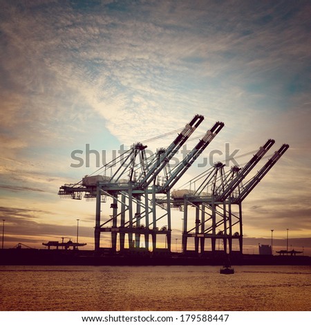Cargo sea port. Sea cargo cranes. Sea. Sunset.