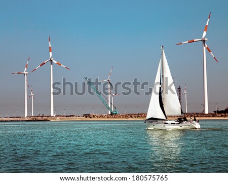 Cargo sea port. Wind turbines. Sea. Yacht.