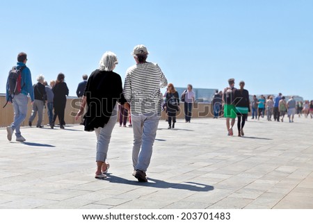 People walking along the seashore. Seascape.