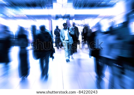 Motion Blurred People.People walking in a corridor, motion blur, toned image.