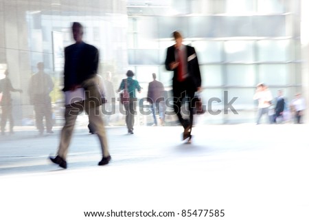 Fast Paced Business World with Blurred Motion. People walking. All exposed faces are motion blurred.