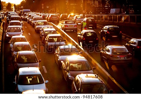 Car traffic against the sunset background.