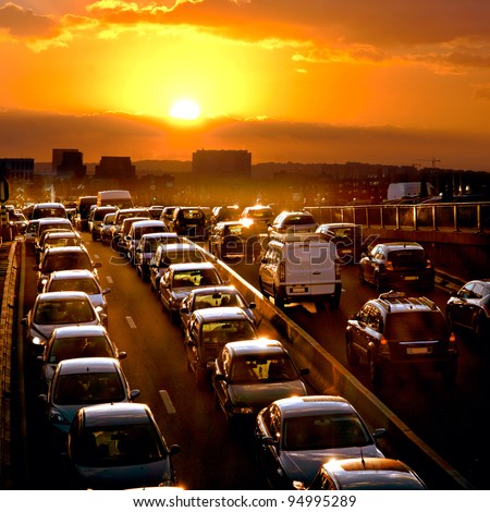 Car traffic against the sunset background.