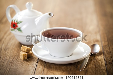 porcelain cup and teapot  on white background