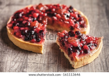 delicious fruit tart dessert on wooden background