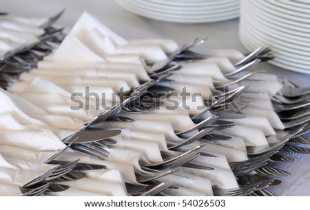 Cutlery wrapped in napkins, waiting for dinner guests