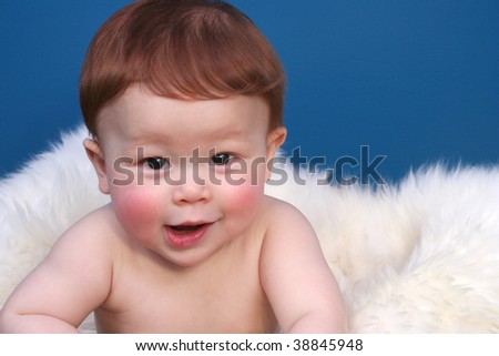 stock photo Close up of redheaded baby with candid pose and facial 