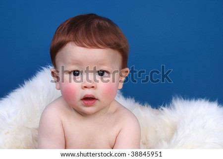 stock photo Close up of redheaded baby with candid pose and facial 