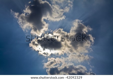 Sun rays with sun behind clouds