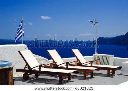 Deck chair on the terrace of a luxury villa in Santorini island, Greece