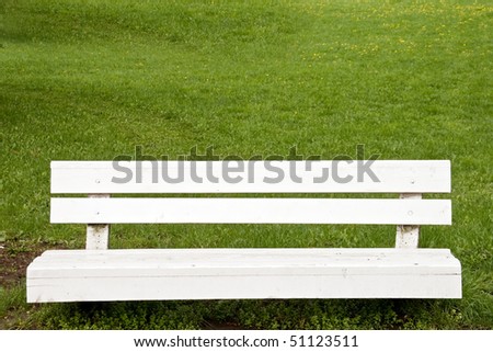 An empty park bench in green park