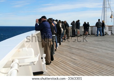 People Standing at Cruise Ship Railing