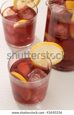 Spanish cuisine. Sangria. Red wine punch served in glasses and a jar in background. Selective focus.