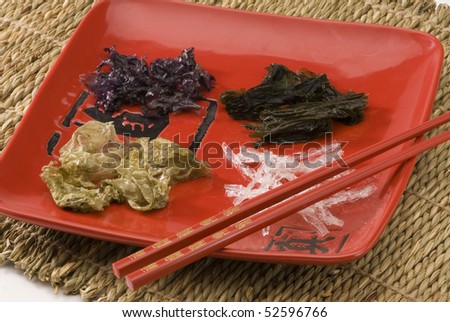 Edible seaweeds in a red plate. Selective focus.
