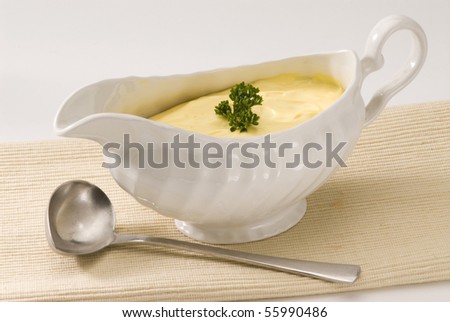 Mayonnaise sauce in a white sauce-boat.