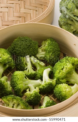 Steamed broccoli in a bamboo steamer. Selective focus.